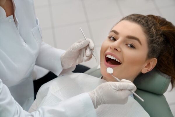 happy-woman-lying-dentist-chair-posing_7502-3727